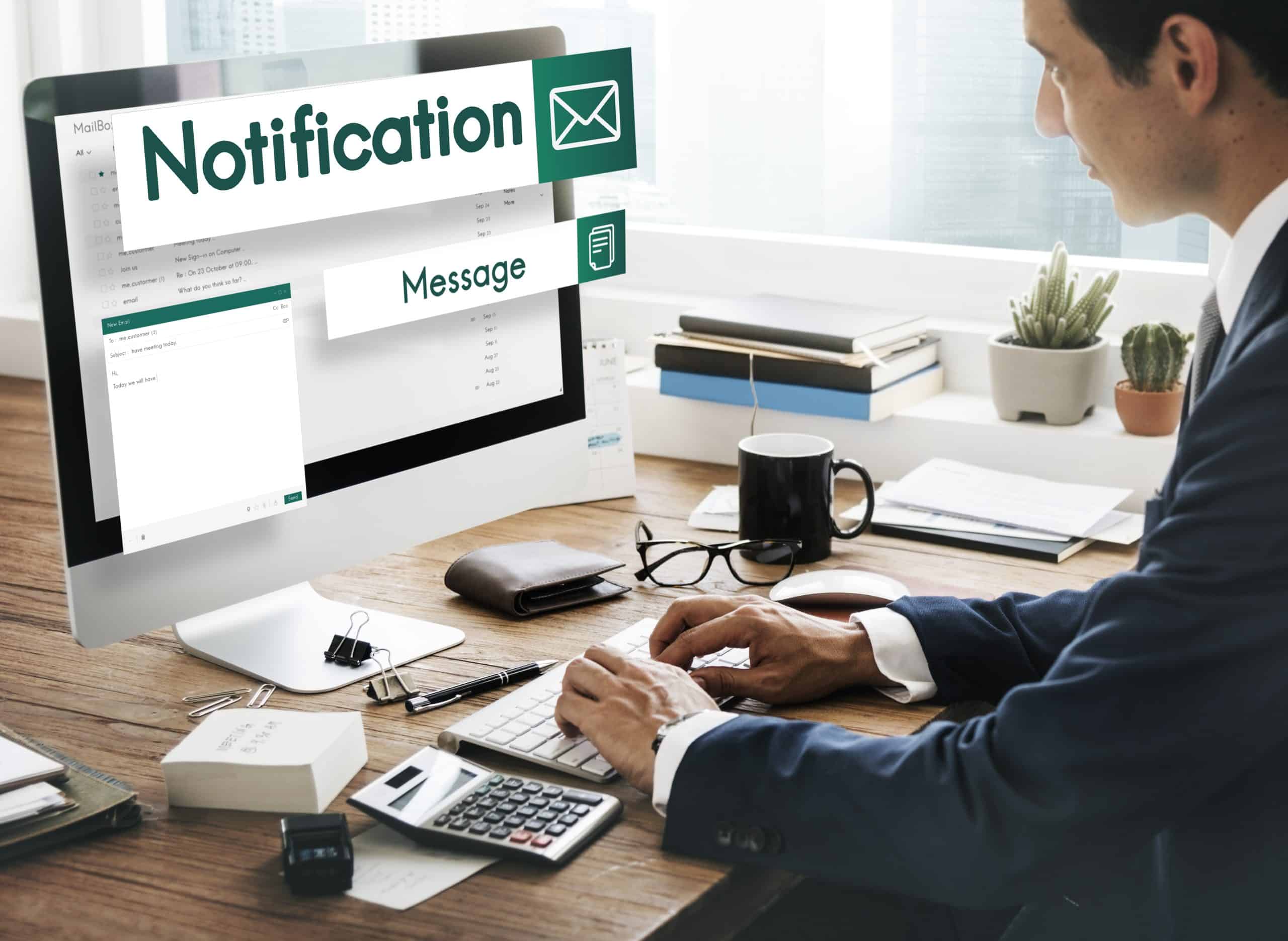 Businessman checking email notifications on computer screen for email marketing.